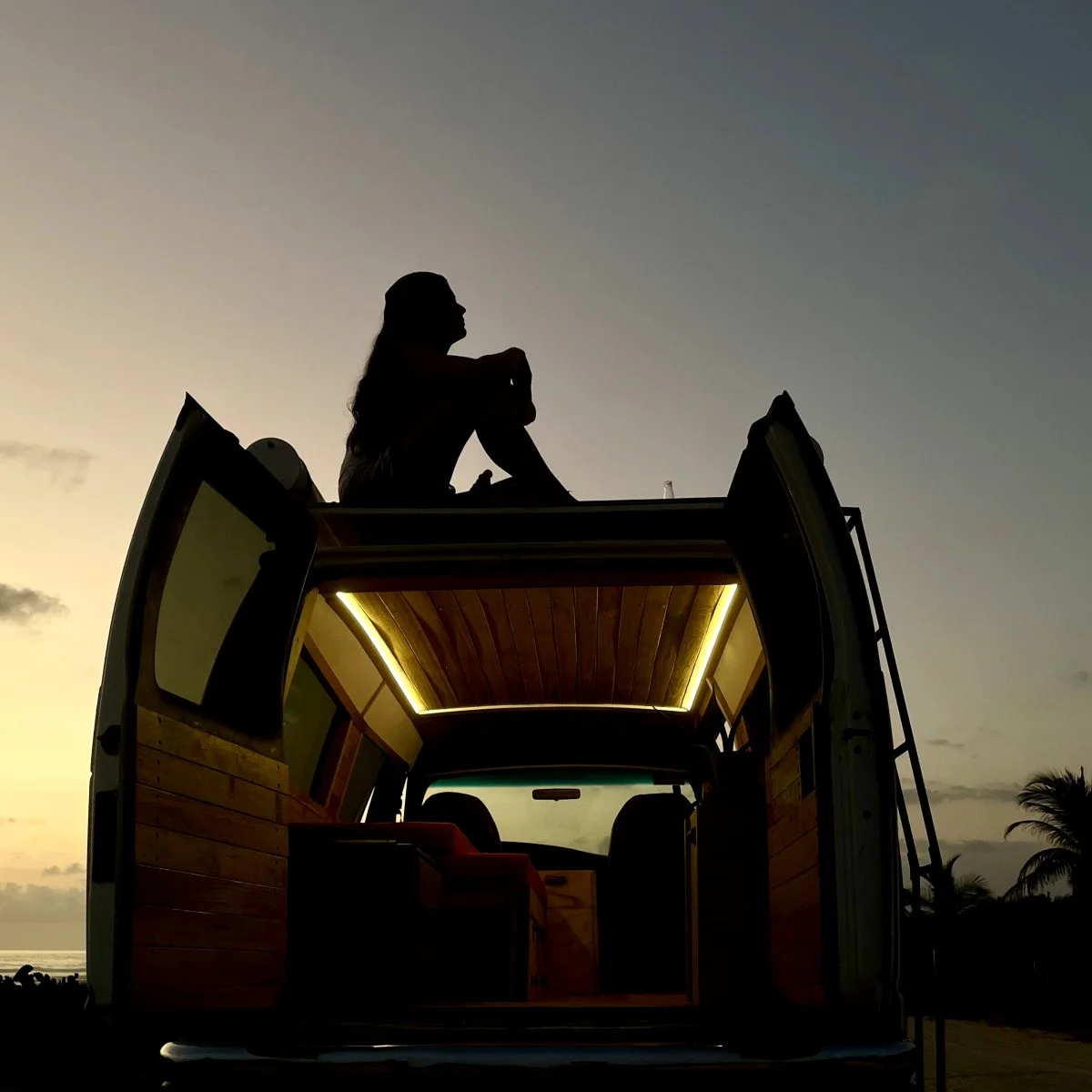 People looking at stars on a campervan rooftent