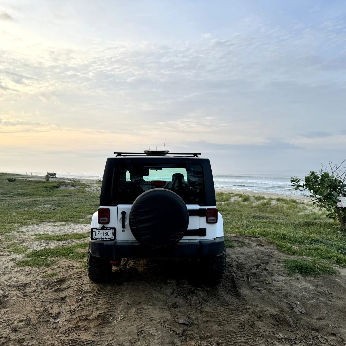 Jeep wrangler from behind on a beach