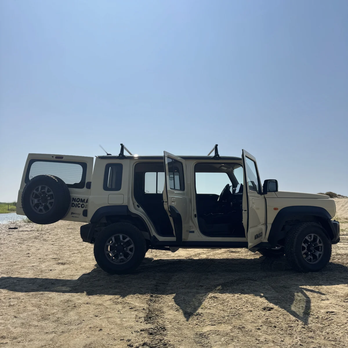 Fully open 4x4 Suzuki Jimny on the beach